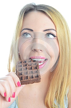 Young woman eating chocolate waffle