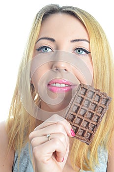 Young woman eating chocolate waffle