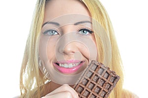 Young woman eating chocolate waffle