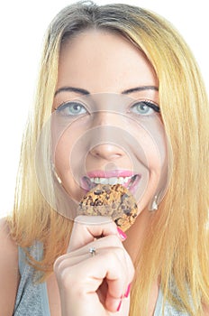 Young woman eating cookie