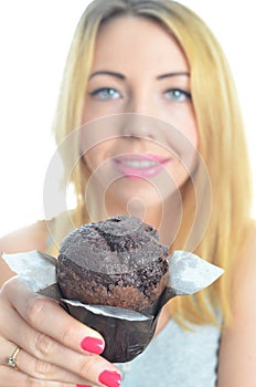 Young woman eating cupcake