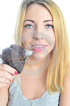 Young woman eating cupcake