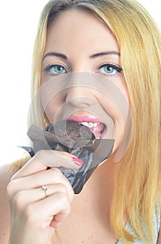 Young woman eating cupcake