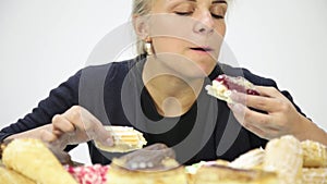 Young woman eating cupcakes with pleasure after a diet