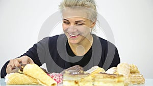 Young woman eating cupcakes with pleasure after a diet