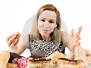 Young woman eating cupcakes with pleasure after a diet