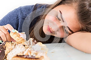 Young woman eating cupcakes with pleasure after a diet