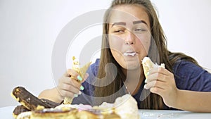 Young woman eating cupcakes with pleasure after a diet