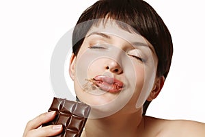 Young woman eating a delicious chocolate