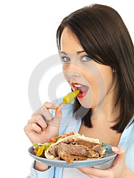 Young Woman Eating Donner Kebab with Salad