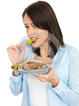 Young Woman Eating Donner Kebab with Salad