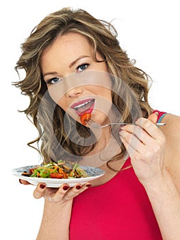 Young Woman Eating a Fresh Crispy Garden Salad
