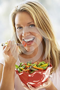 Young Woman Eating Fresh Salad