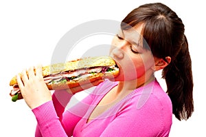 Young woman eating a freshly made sub sandwich