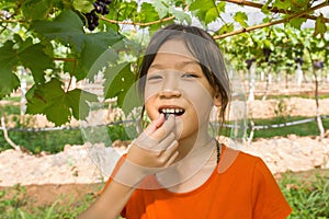 Young woman eating grapes