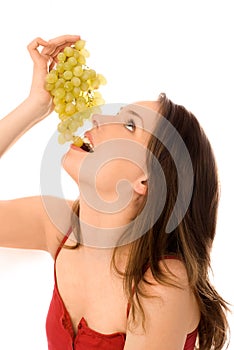 Young woman eating grapes