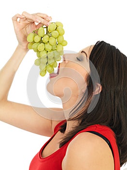 Young Woman Eating Green Grapes