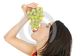 Young Woman Eating Green Grapes