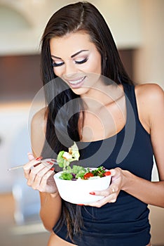 Young woman eating a healthy fresh salad