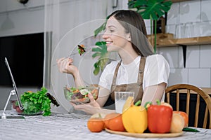 Young woman eating healthy fruit breakfast in bowl at home. Healthy food