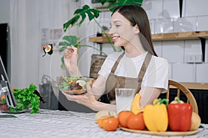 Young woman eating healthy fruit breakfast in bowl at home. Healthy food