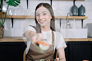 Young woman eating healthy fruit breakfast in bowl at home. Healthy food