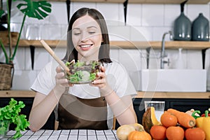 Young woman eating healthy fruit breakfast in bowl at home. Healthy food