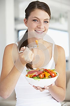 Young Woman Eating A Healthy Salad