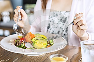 Young woman eating healthy salad at restuarant, Healthy lifestyle photo