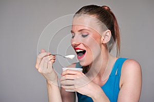 Young woman eating her yoghurt