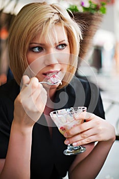 Young woman eating an ice cream