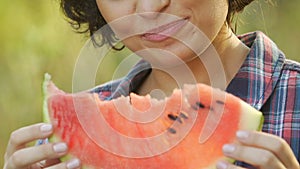 Young woman eating juicy watermelon on summer picnic and smiling, vitamins