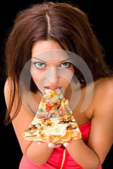 Young woman eating a piece of pizza