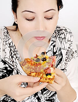 Young woman eating pizza