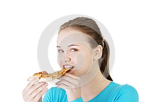 Young woman eating pizza.