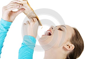 Young woman eating pizza.