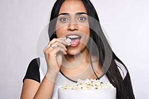 Young woman eating popcorn