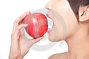 Young woman eating red apple with health teeth