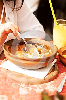 Young woman is eating in restaurant.