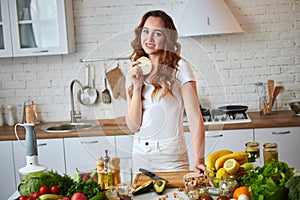 Young woman eating rye cracker crisp bread in the kitchen. Healthy Lifestyle. Health, Beauty, Diet Concept