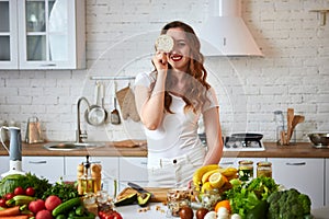 Young woman eating rye cracker crisp bread in the kitchen. Healthy Lifestyle. Health, Beauty, Diet Concept