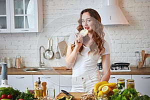 Young woman eating rye cracker crisp bread in the kitchen. Healthy Lifestyle. Health, Beauty, Diet Concept