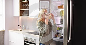 Young woman eating sandwich in front