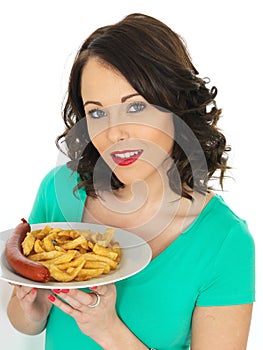 Young Woman Eating Saveloy Sausage and Chips