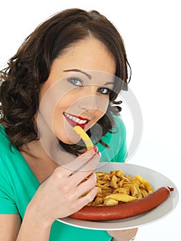 Young Woman Eating Saveloy Sausage and Chips