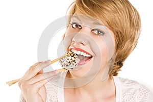 Young woman eating sushi