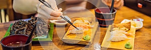 Young woman eating sushi in a cafe BANNER, LONG FORMAT