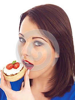 Young Woman Eating Toasted Crumpet with Cream Cheese and Tomato