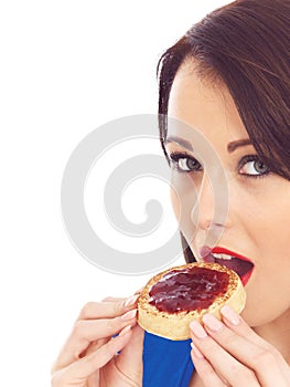 Young Woman Eating Toasted Crumpet and Jam