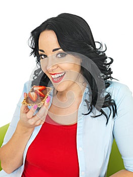 Young Woman Eating Wholegrain Cracker with Chocolate Spread and Fresh Sliced Strawberries